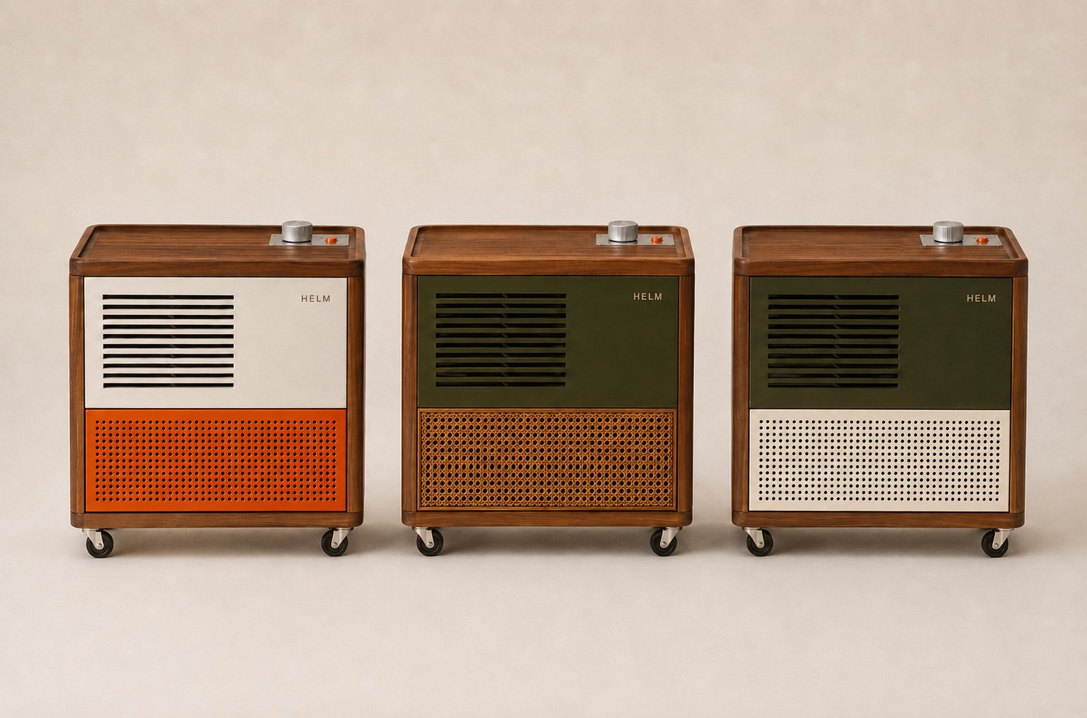 Three HELM One cabinets in a row, each in walnut on castors: a Chalk panel over a Signal Orange steel grille, a Lamp Green panel over cane, and a Lamp Green panel over a Chalk steel grille