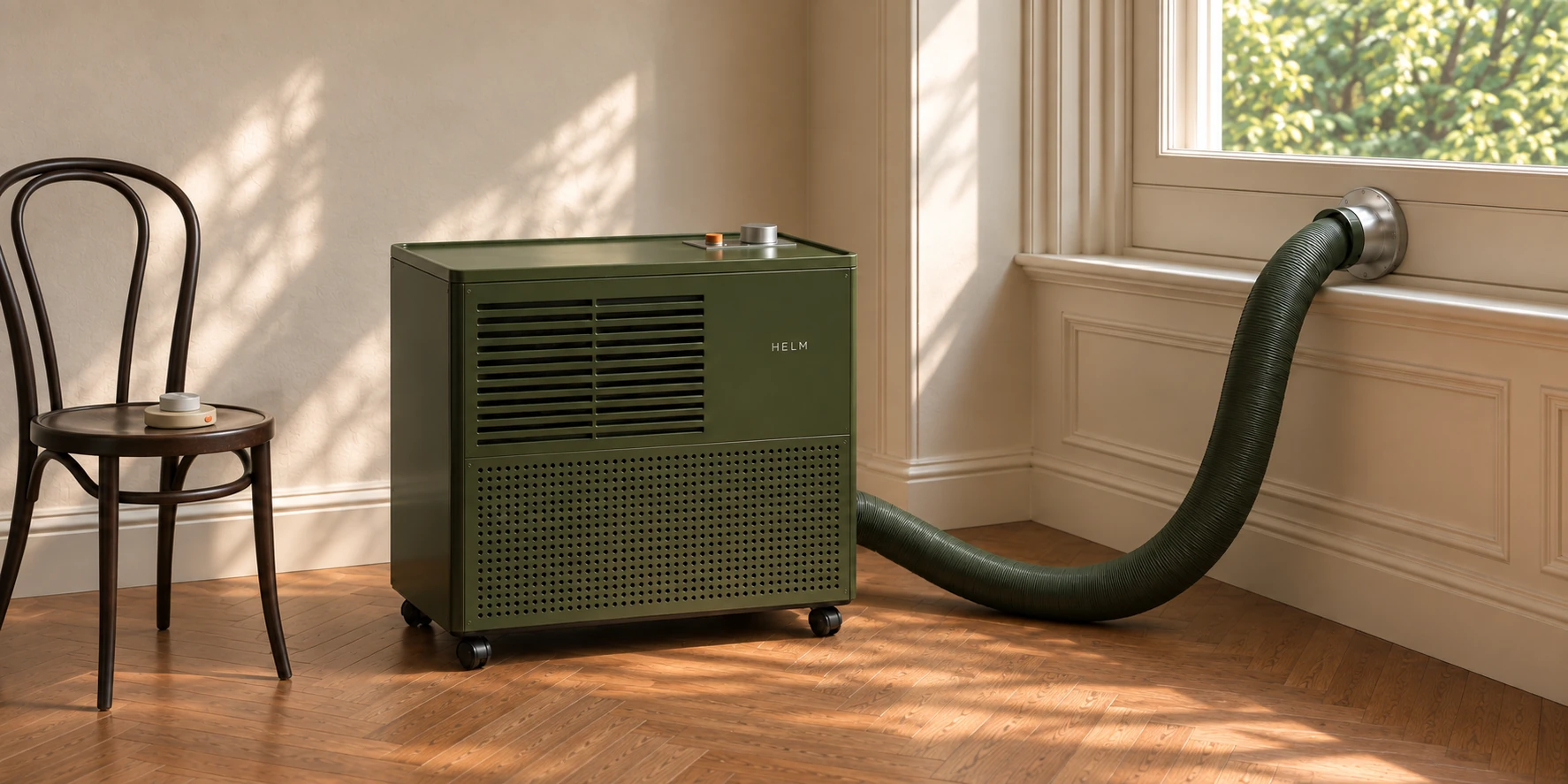 HELM One in Lamp Green satin metal, its green ribbed hose rising to the porthole in the window, the Bedside Crown resting on a bentwood chair