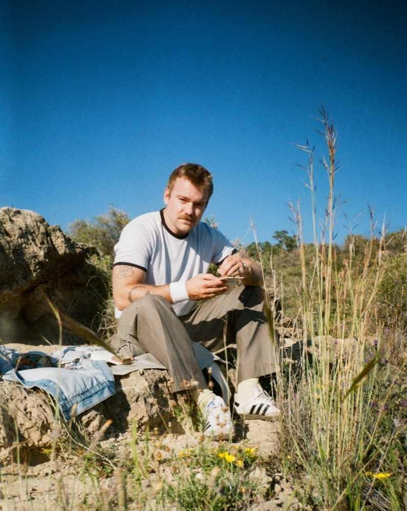 The Englishman sketching outdoors on a sunlit hillside