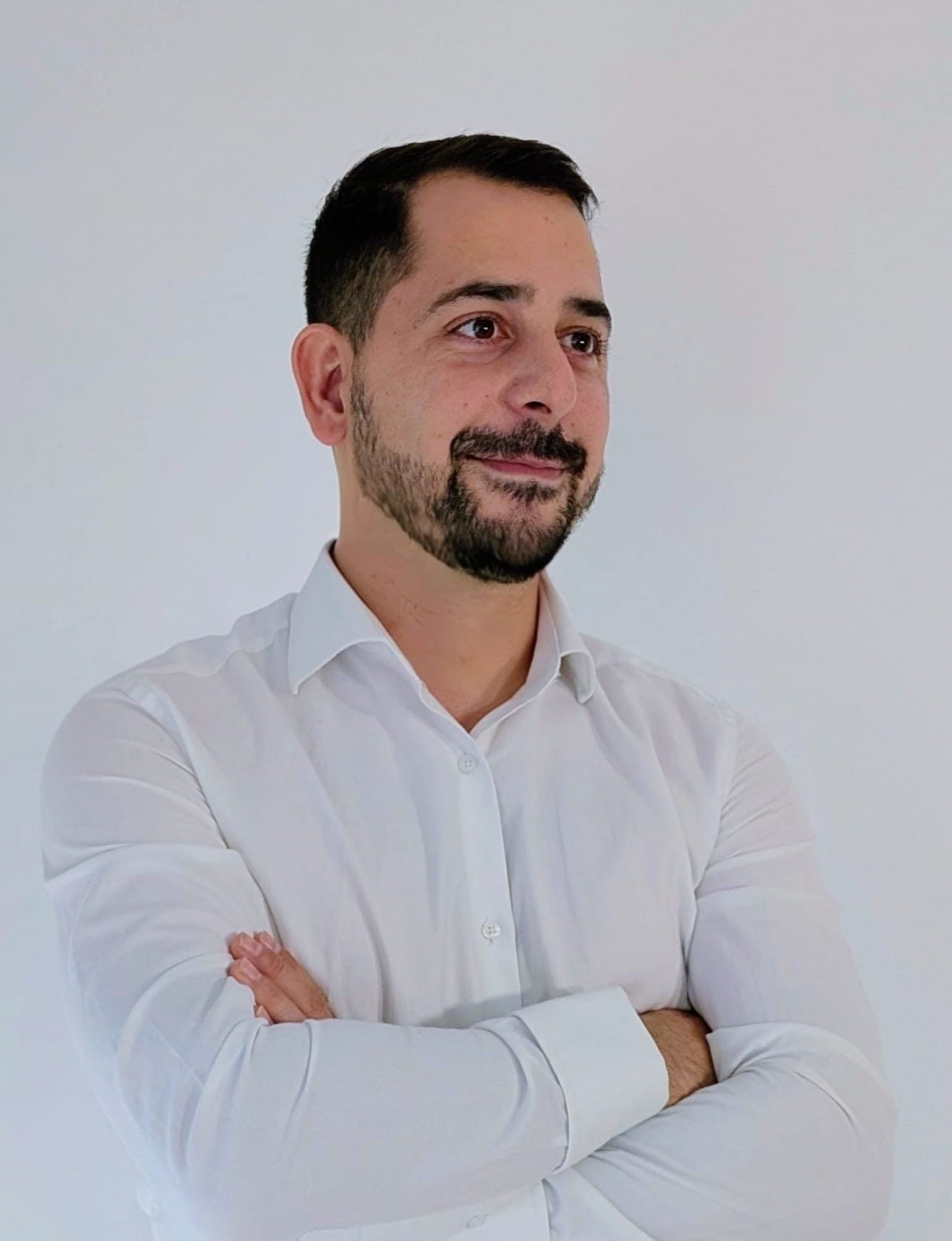The Spaniard in a white shirt, arms folded
